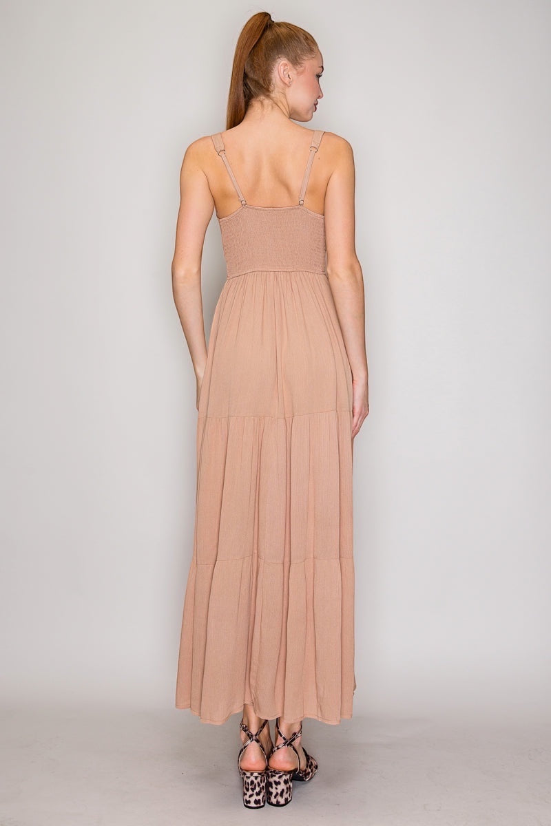 Front Tie High Slit Shirred Maxi Dress.  With a square neckline that says "I have excellent taste" and a sleeveless design that screams "I'm confident," you'll be turning heads at every event. The shirred detail adds just enough texture to keep things interesting, while the lightweight rayon fabric lets you breathe like you actually enjoy being alive. The front-tie detail and high slit?