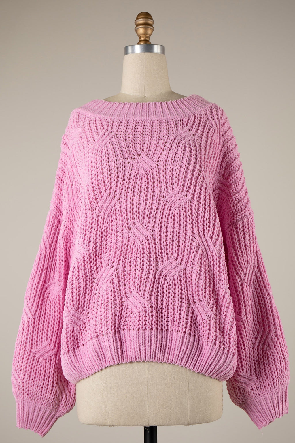 Luxe Life Styled pink crochet knit sweater with staircase braid pattern, ribbed trim, and boat neck. Made from 55% cotton and 45% acrylic.