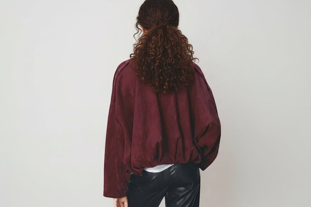 Luxe Life Styled wine faux suede bomber jacket with bat wing sleeves and full zip-up front.