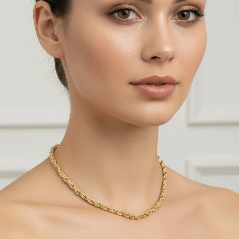 Gold rope chain bracelet on a clear background